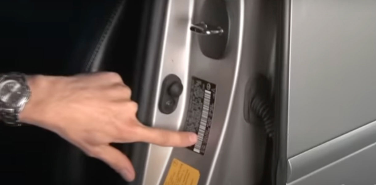 finding your vehicles color code, pointing to code on inside of card door